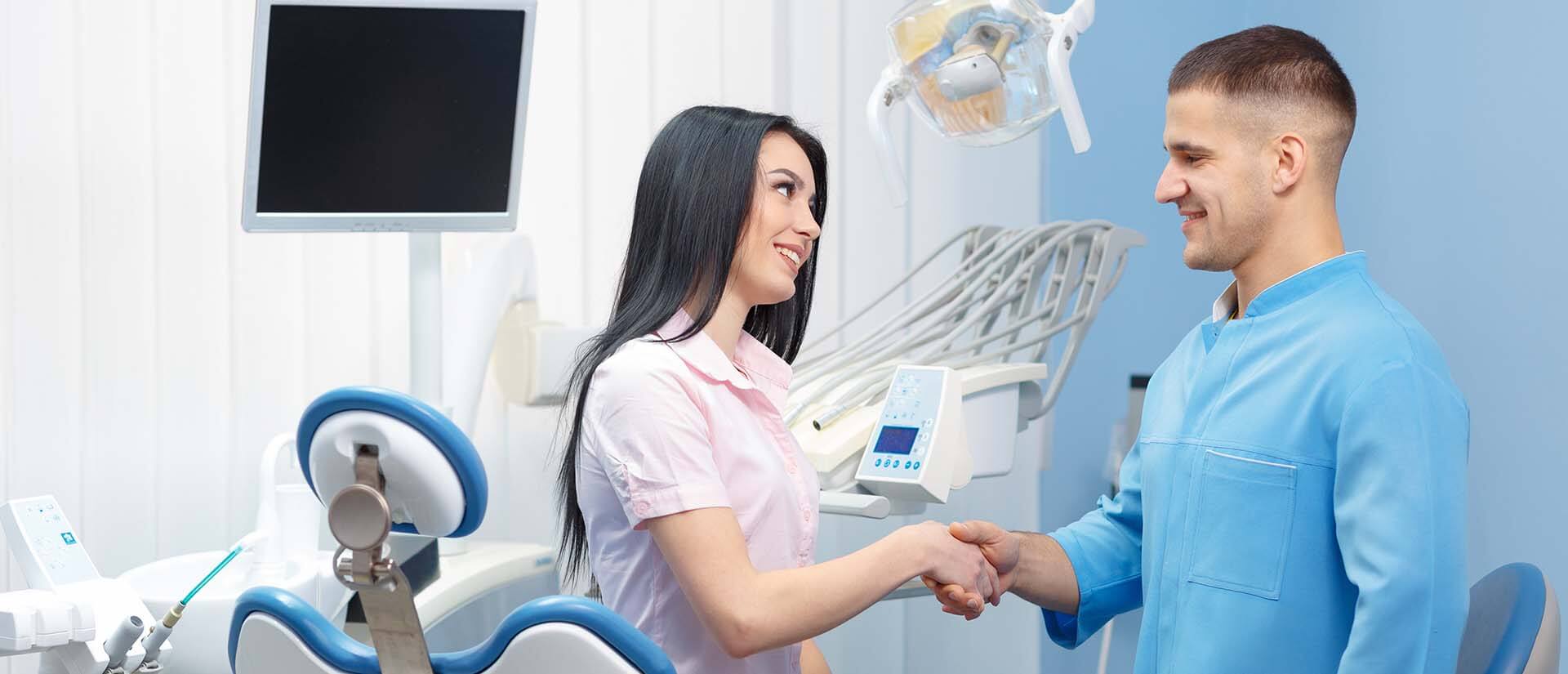 A woman shaking hands with a dentist